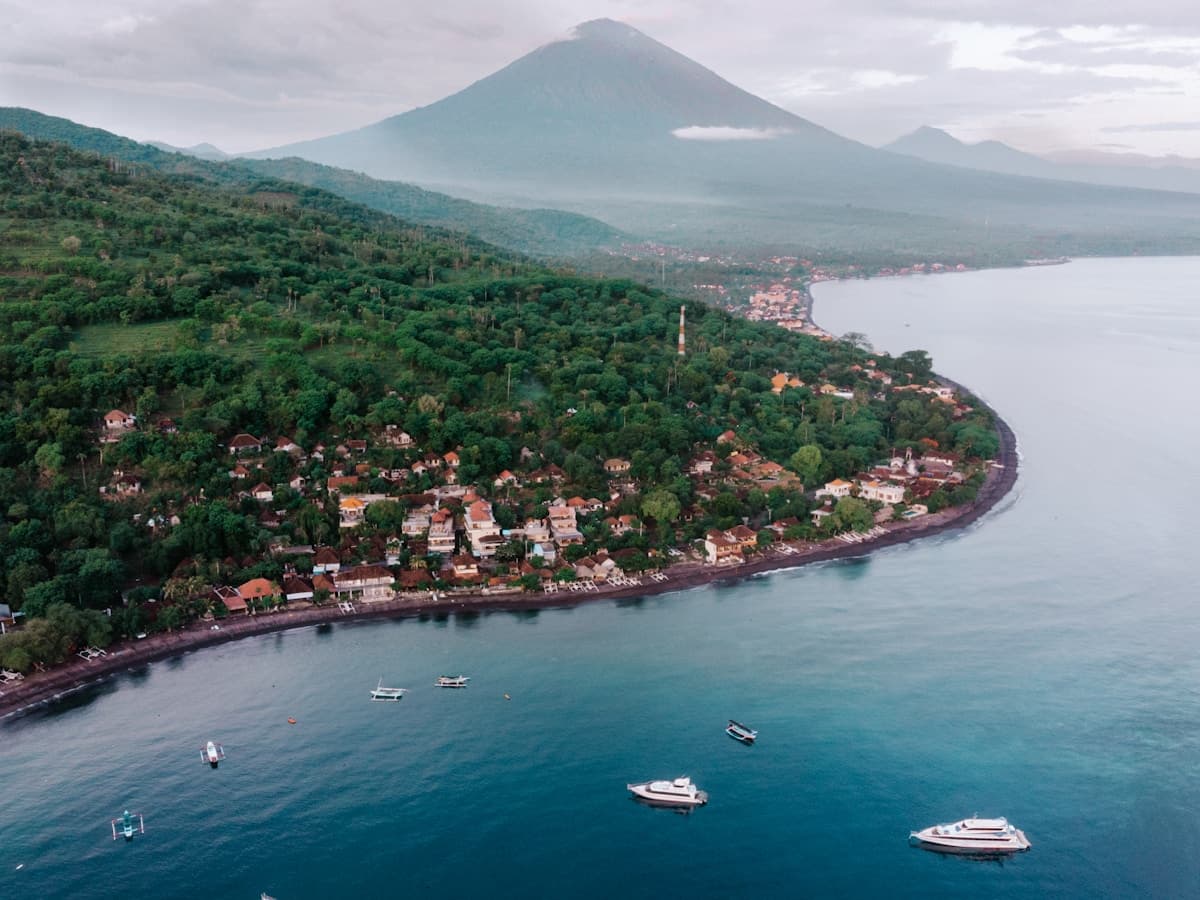 Bali Amed — traditional jukung fishing boats lined up under Mount Agung