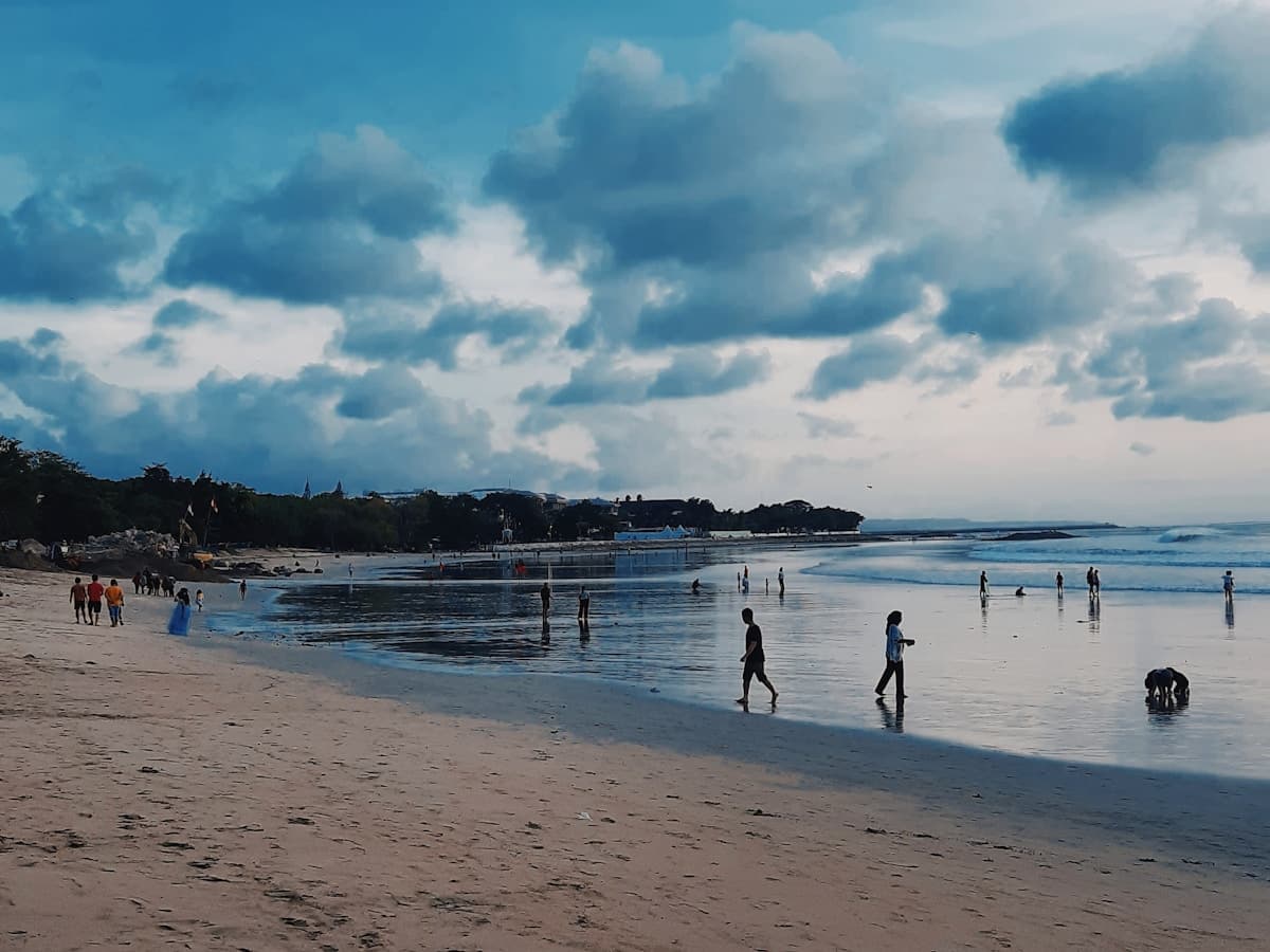 Bali Kuta โ long sandy beach with surfboards lined up at sunset