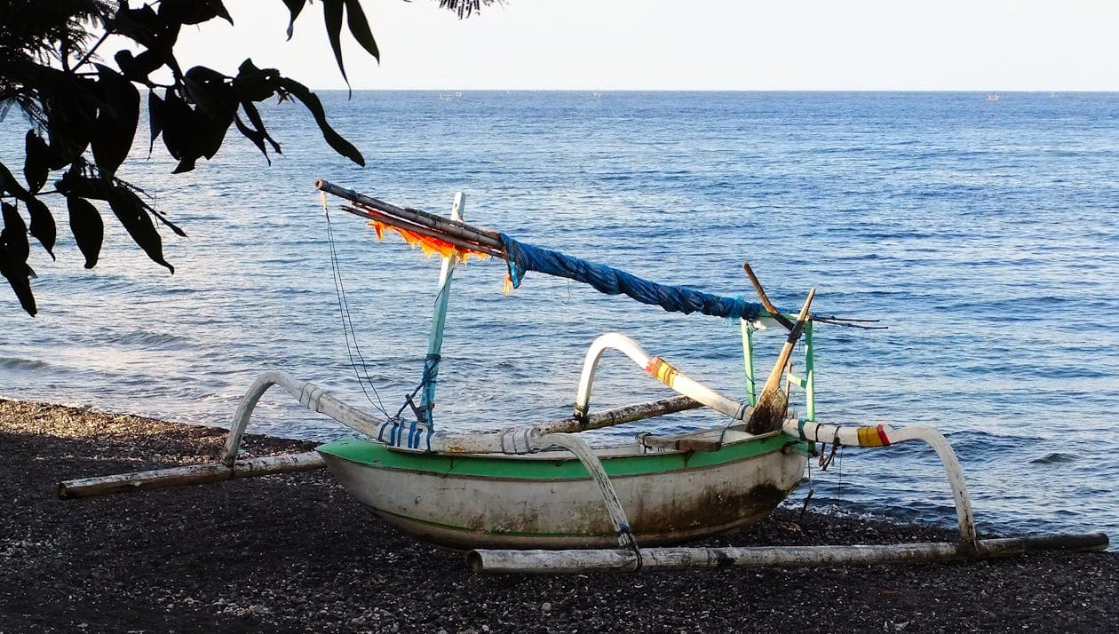 Bali — traditional fishing boats on the black sand beach at Amed, east Bali